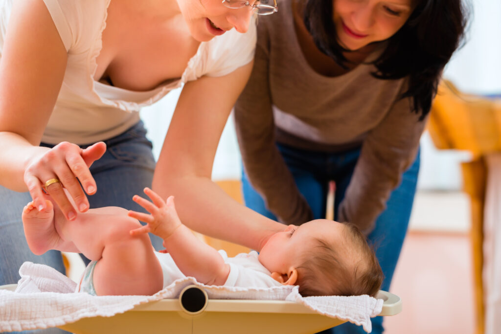 Midwife Measuring Weight Or Newborn Baby